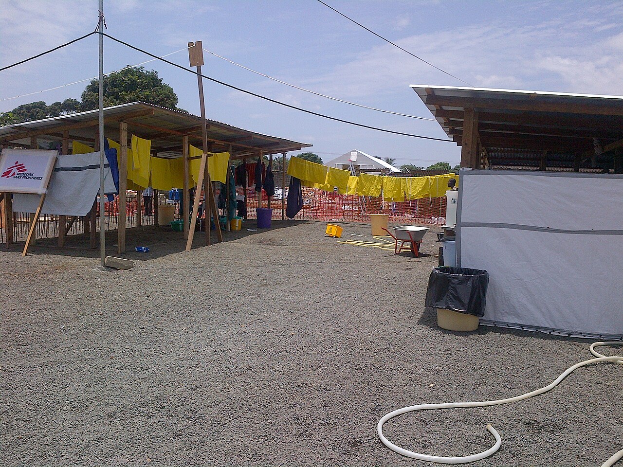 An Ebola treatment unit, protective suits hung out to dry.