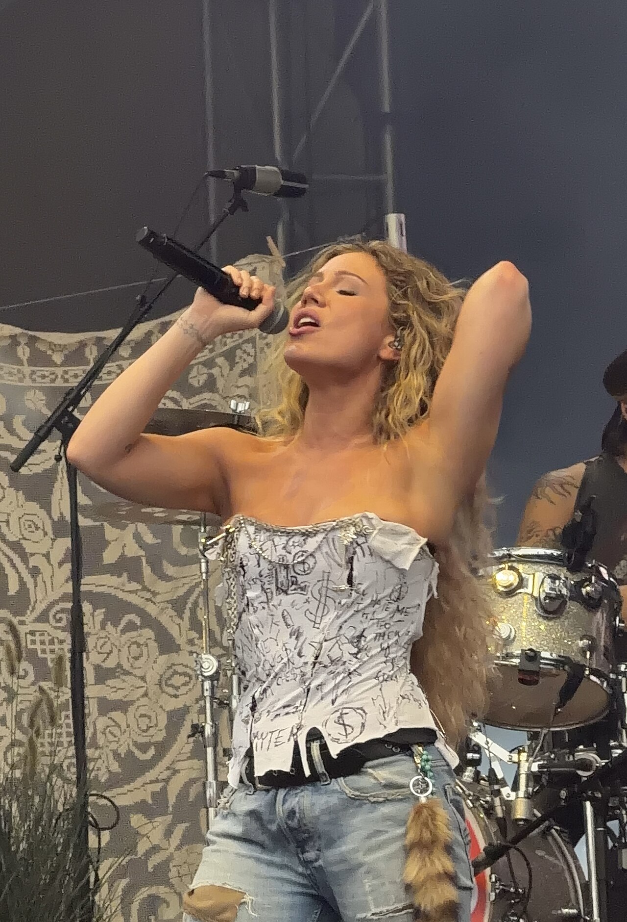 Slayyyter performing live on stage in Edmonton in 2026.